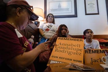 Family members of the Robb Elementary shooting victims and their supporters wait to meet with an aide of a state senator to ask the lawmaker to consider supporting gun reform legislation.