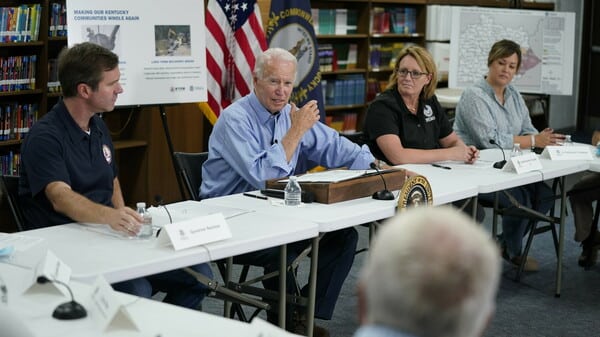 President Biden gets a briefing in Lost Creek, Ky., after touring flood damage. He vowed that communities in the state would get help to rebuild after the disaster.